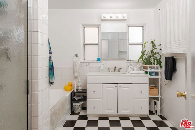 bathroom with vanity, tile walls, and separate shower and tub