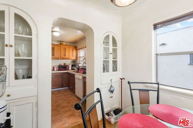 kitchen with white dishwasher and light tile patterned floors