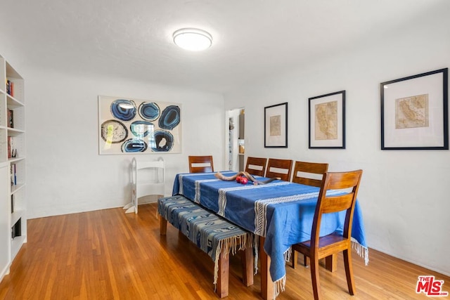 dining space with wood-type flooring