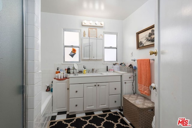 bathroom featuring vanity, plenty of natural light, an enclosed shower, and decorative backsplash