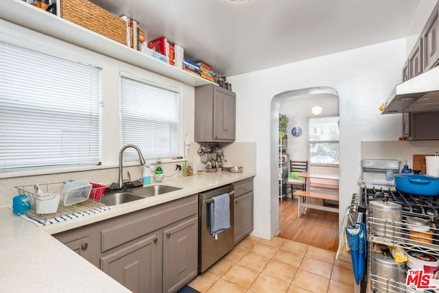 kitchen with light tile patterned floors, stainless steel appliances, sink, and gray cabinetry