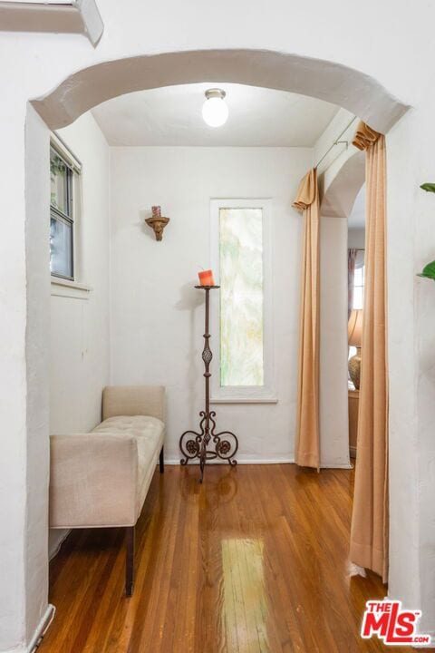 unfurnished room with wood-type flooring and a wall mounted AC