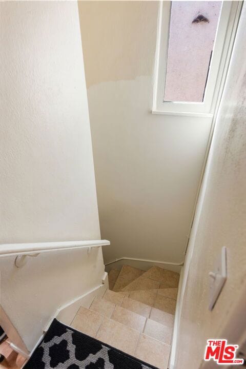 staircase featuring tile patterned floors