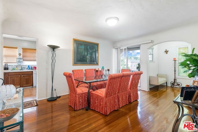 dining space with sink and hardwood / wood-style floors