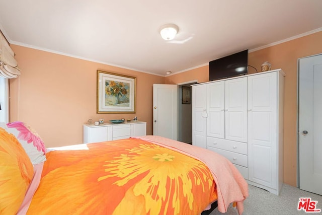 carpeted bedroom with a closet and crown molding