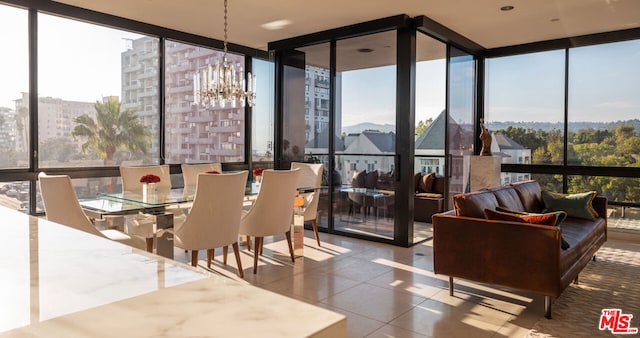 sunroom / solarium with a chandelier