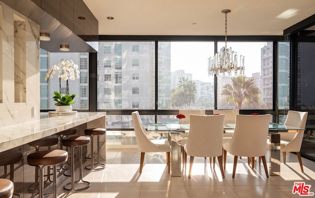 tiled dining space featuring a wall of windows, a notable chandelier, and plenty of natural light