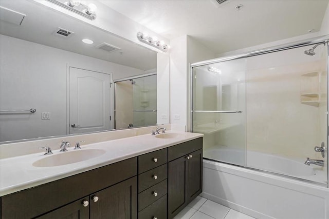 bathroom featuring tile patterned floors, vanity, and combined bath / shower with glass door