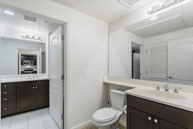 bathroom featuring toilet, tile patterned floors, and vanity