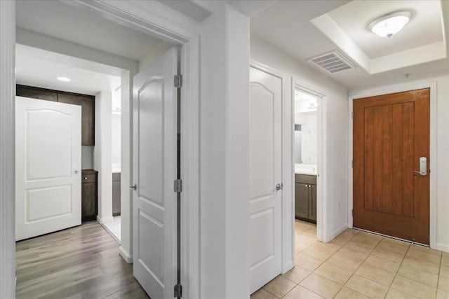 hallway featuring light tile patterned flooring