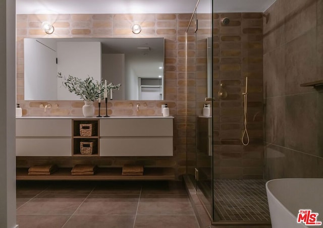 bathroom with backsplash, tile patterned floors, vanity, tile walls, and plus walk in shower