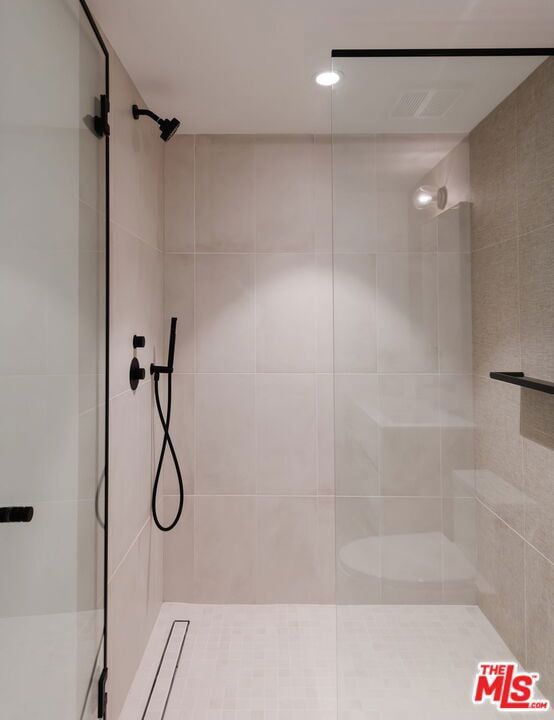 bathroom with a tile shower