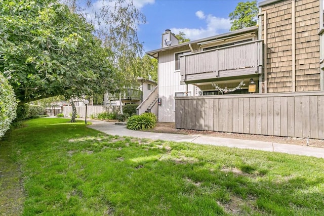 view of yard with a balcony