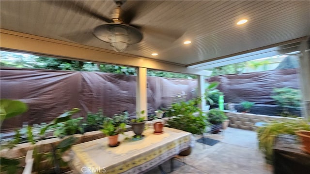 sunroom / solarium featuring ceiling fan