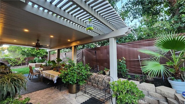 view of patio featuring ceiling fan and a pergola