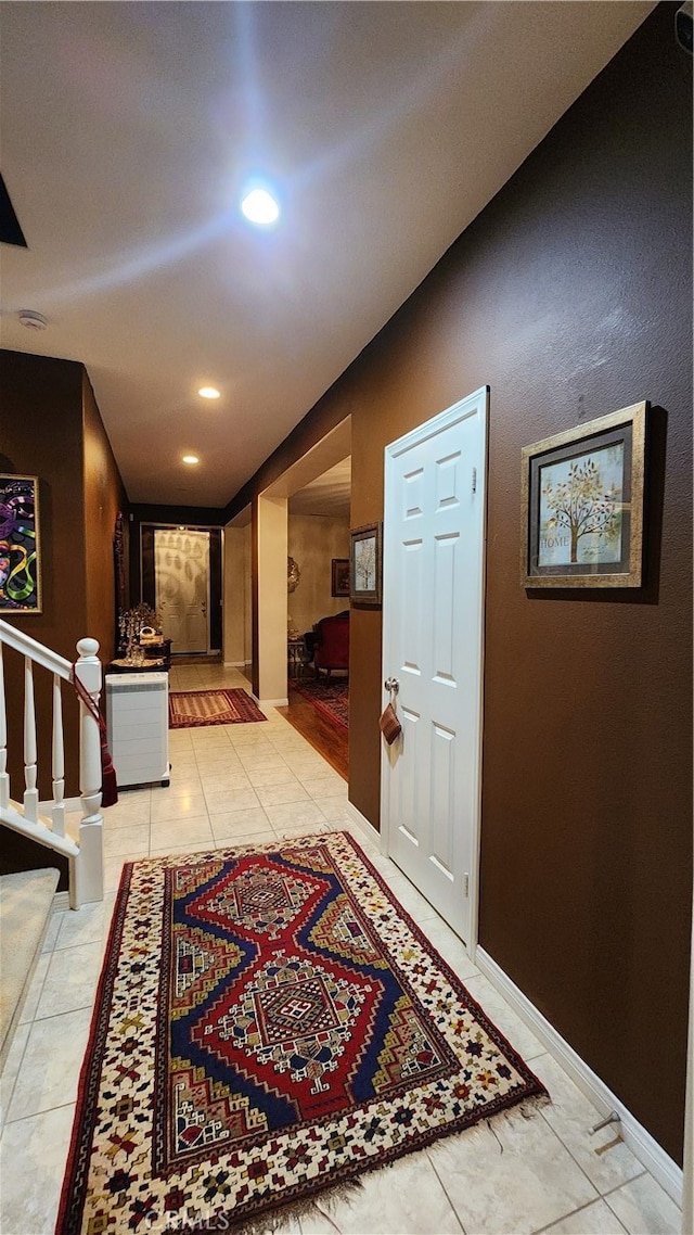 hall featuring light tile patterned flooring