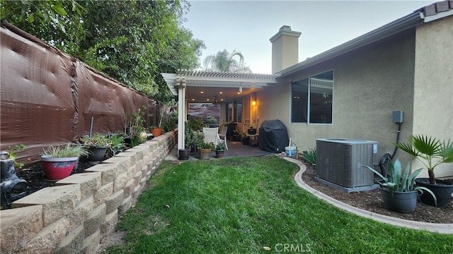 view of yard featuring a patio and central AC unit