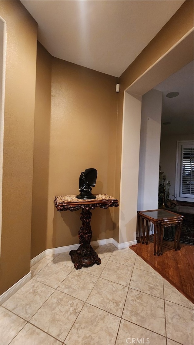 hallway featuring light tile patterned floors