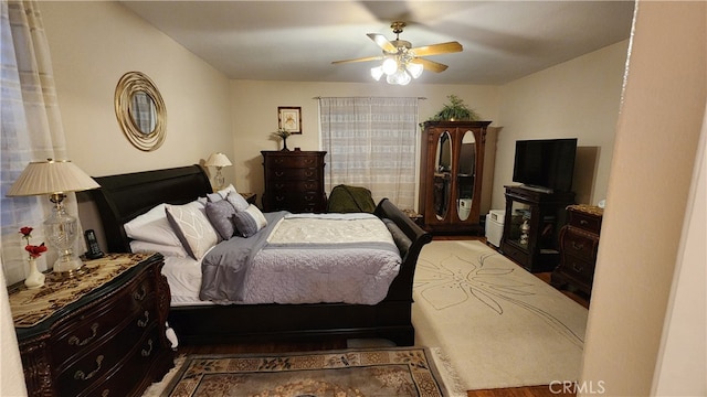 bedroom with hardwood / wood-style flooring and ceiling fan