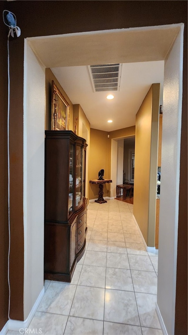 hallway featuring light tile patterned floors