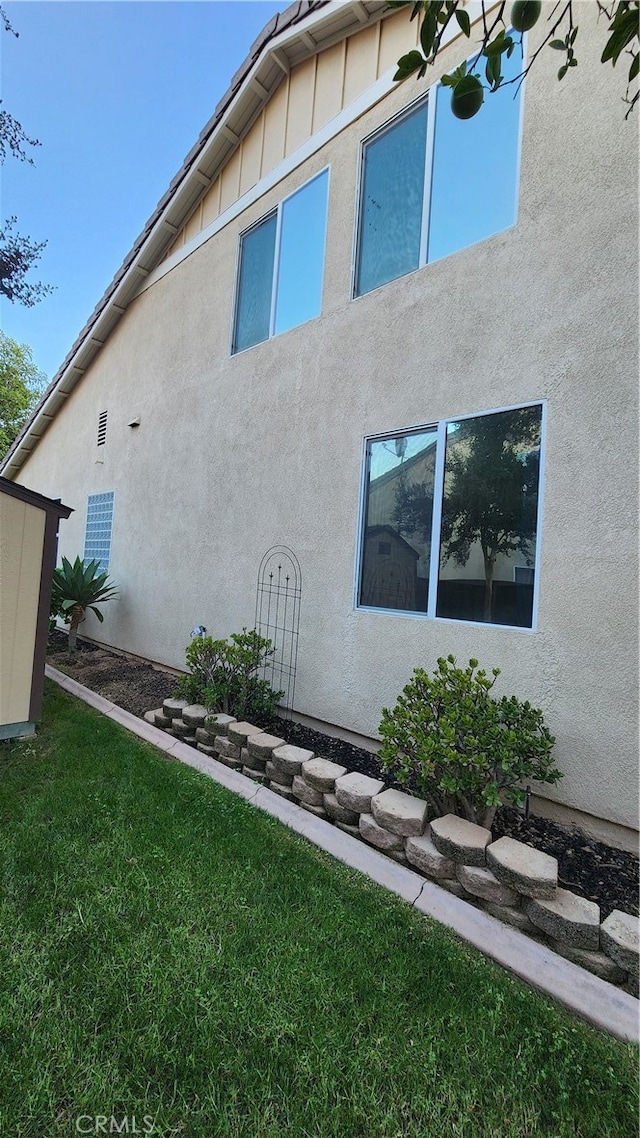 view of property exterior featuring a lawn