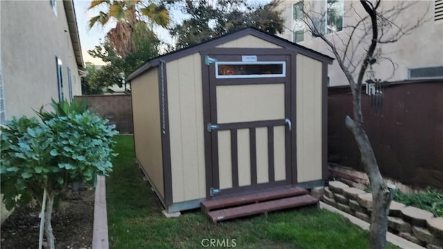 view of shed with fence