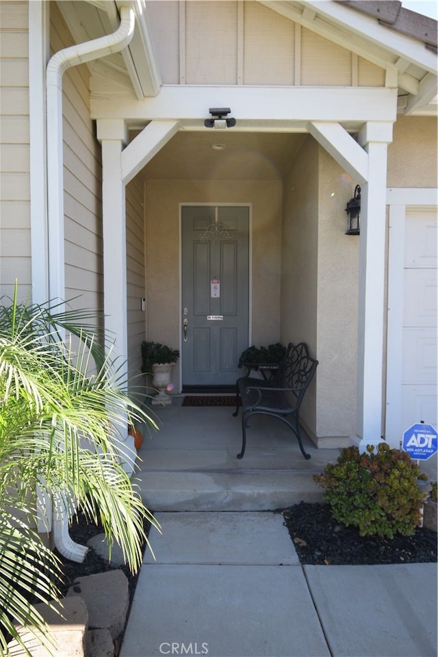 entrance to property with a porch and a garage