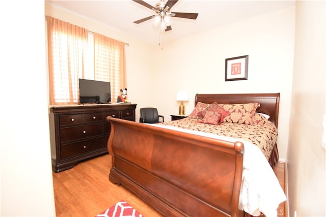 bedroom with light hardwood / wood-style flooring and ceiling fan