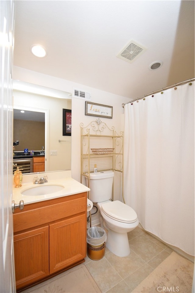 bathroom featuring vanity, curtained shower, toilet, and tile patterned flooring