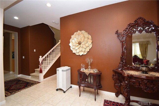 staircase featuring tile patterned flooring