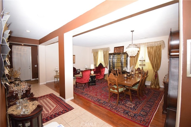 dining space with an inviting chandelier and light wood-type flooring