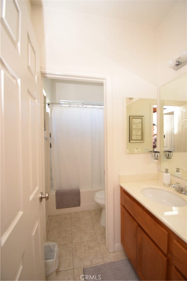 full bathroom featuring vanity, toilet, shower / bath combo with shower curtain, and tile patterned flooring