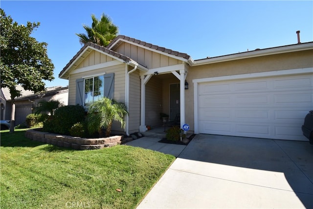 view of front of house featuring a front yard and a garage