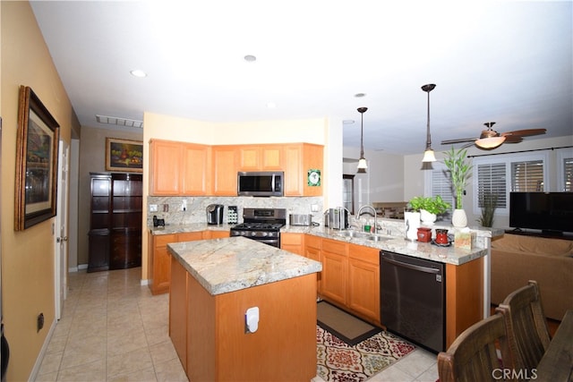 kitchen featuring backsplash, a center island, kitchen peninsula, stainless steel appliances, and decorative light fixtures