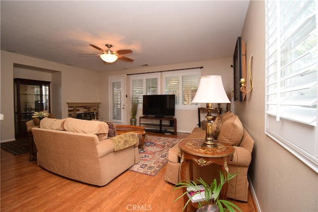 living room featuring hardwood / wood-style floors and ceiling fan