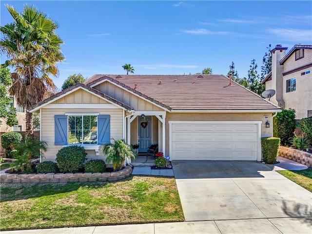 view of front facade featuring a tile roof, an attached garage, board and batten siding, driveway, and a front lawn