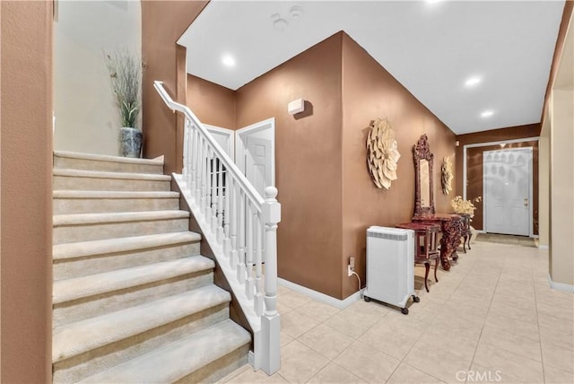 stairway with recessed lighting, baseboards, and tile patterned floors