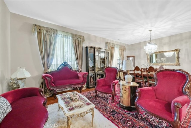 living area with a chandelier and wood finished floors