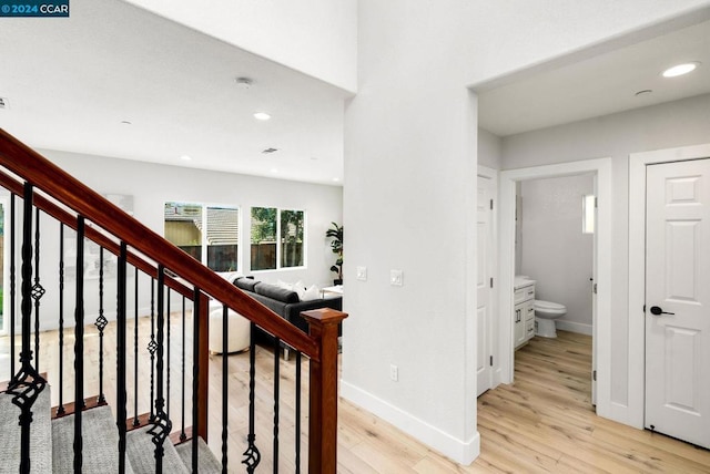 stairs with hardwood / wood-style floors