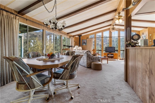 sunroom featuring ceiling fan with notable chandelier, lofted ceiling with beams, and a healthy amount of sunlight