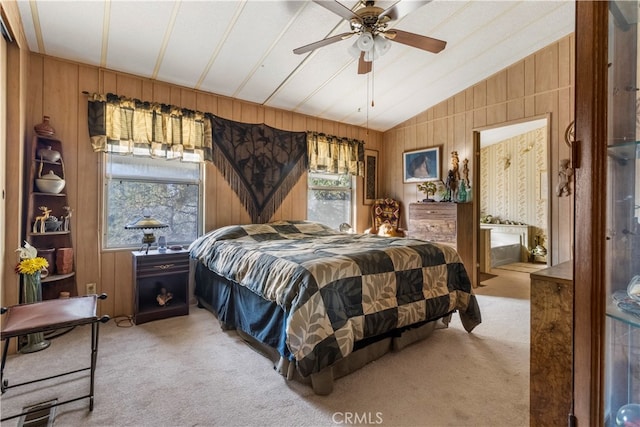 bedroom with wooden walls, ceiling fan, vaulted ceiling, and carpet flooring