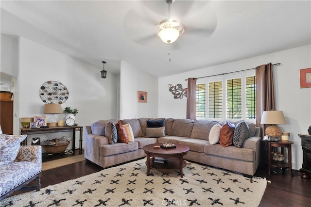 living room featuring ceiling fan and dark hardwood / wood-style floors