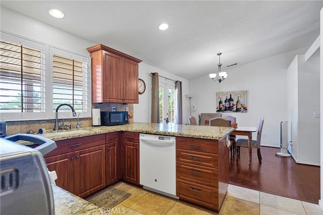 kitchen featuring sink, light hardwood / wood-style floors, kitchen peninsula, hanging light fixtures, and dishwasher