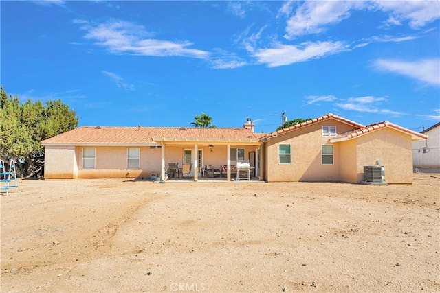 rear view of house with a patio and cooling unit