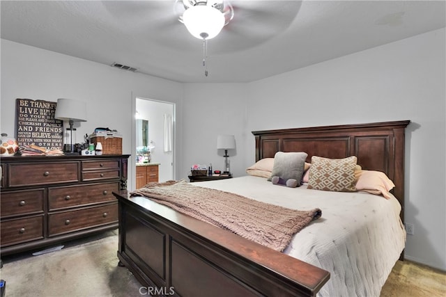 carpeted bedroom featuring ensuite bathroom and ceiling fan