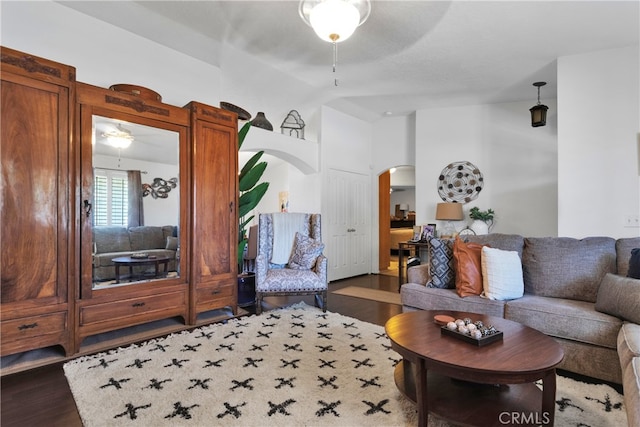 living room with ceiling fan and dark hardwood / wood-style floors