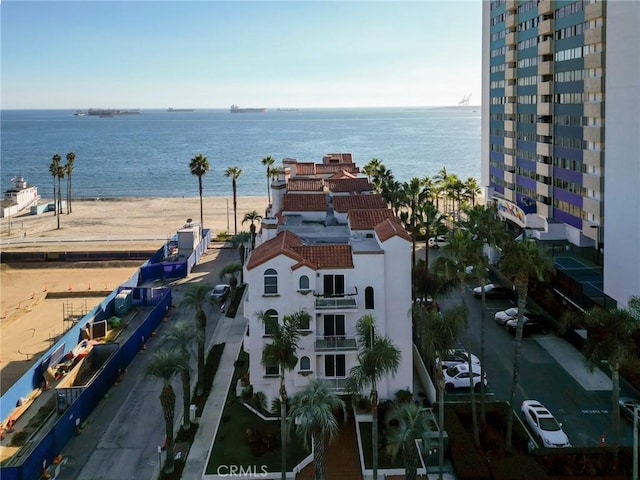 exterior space with a water view and a view of the beach