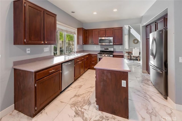 kitchen featuring a kitchen island, sink, and stainless steel appliances