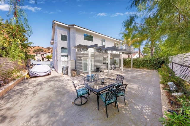 rear view of house with a pergola and a patio area