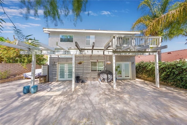 back of house with a patio area, a wooden deck, and french doors